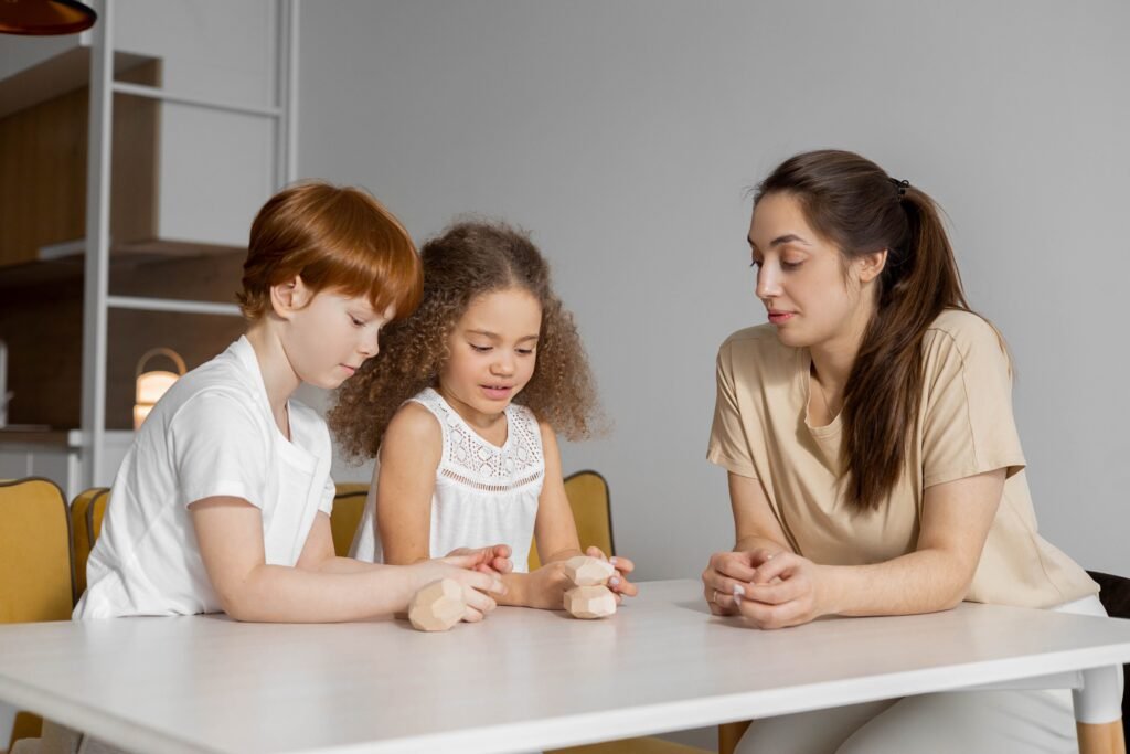 Babysitter doing a fun activity with two children at a table