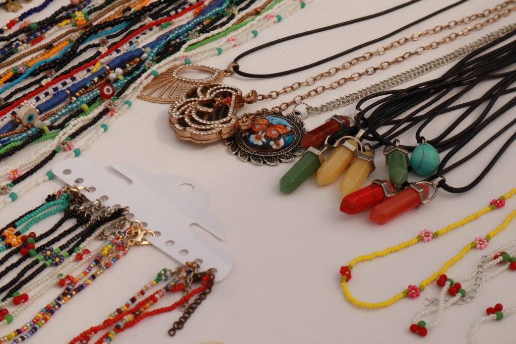 Colorful handmade beaded bracelets and necklaces laid out on a table