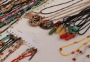 Colorful handmade beaded bracelets and necklaces laid out on a table