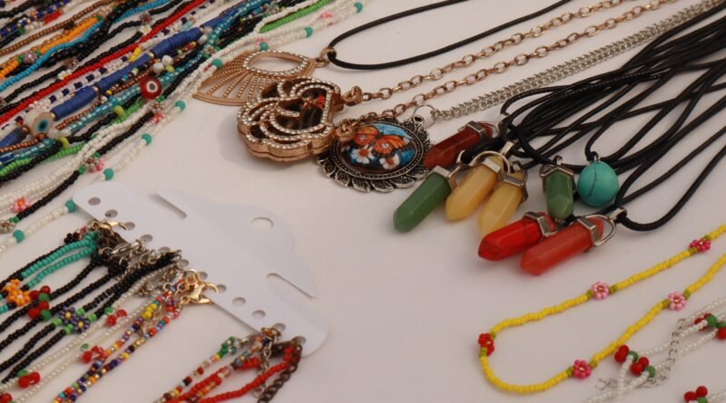 Colorful handmade beaded bracelets and necklaces laid out on a table
