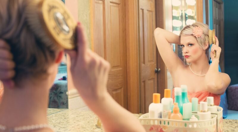 Woman brushing her hair in front of a mirror