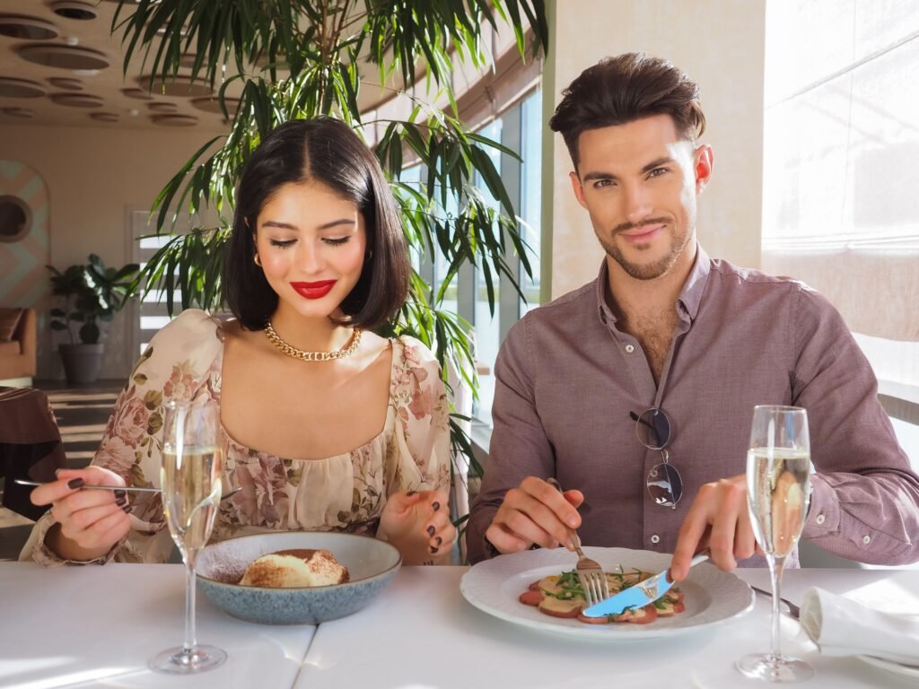 Smiling couple enjoying a special meal together at a bright cafe table