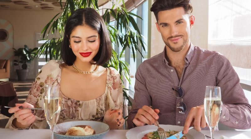 Smiling couple enjoying a special meal together at a bright cafe table