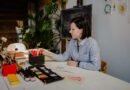 Woman working at a tidy desk in a bright room with plants